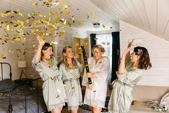Four girls having fun in Hotel Nestor room in the wedding day