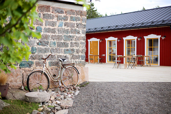 A beautiful view of Hotel Nestor with an old bike in the foreground, and the new restaurant area in the background